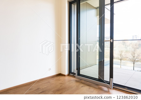 Tilt and slide glass door system for modern balcony access in residential apartment interior 123862010
