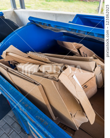 Recycling bin with discarded cardboard waste for sustainable waste management 123862025
