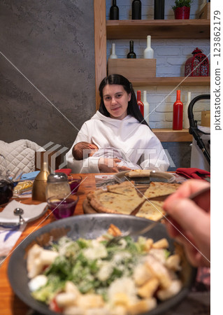 Cozy Family Dining with Breastfeeding Mother 123862179