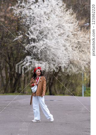 Woman in Red Beret with Blooming Trees 123862220