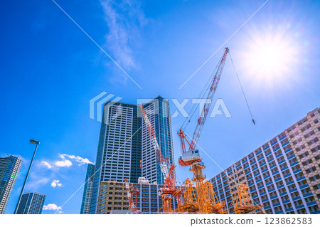 Tokyo cityscape in Japan: Cranes shining against the blue sky... Kachidoki Pump Building Construction Tokyo cityscape in Japan: Cranes shining against the blue sky... Kachidoki Pump Building Construction 123862583
