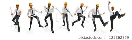 Playful construction engineer in white shirt and yellow helmet joyfully moving with rolled-up blueprints, showcasing enthusiasm. 123862869