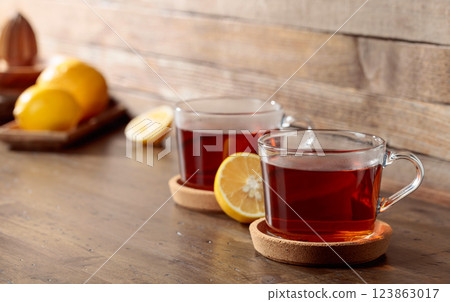 Tea with lemon on a wooden table. 123863017