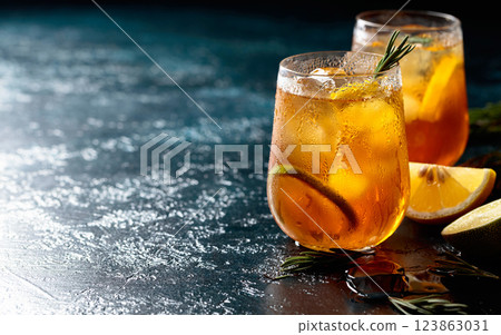 Refreshing hard seltzer with lemon, lime and ice garnished with rosemary twigs. 123863031