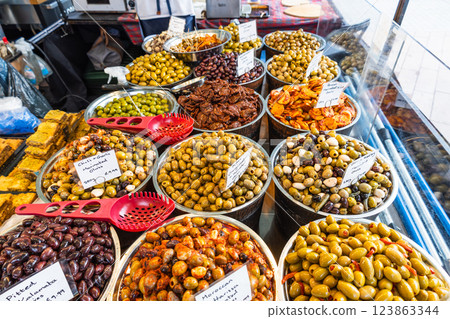 Vibrant Street Market Stall Displaying Various Fresh Olives and Local Delicacies Vibrant Street Market Stall Displaying Various Fresh Olives and Local Delicacies 123863344