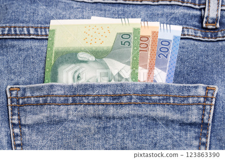 Moroccan dirham in the pocket of blue jeans Moroccan dirham in the pocket of blue jeans 123863390