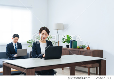 Group of male and female business people working on laptops in an office 123863975