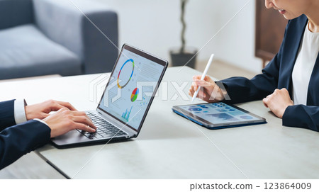 A group of male and female business people working in an office 123864009