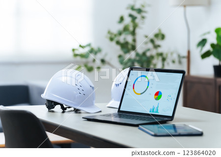 Laptop and helmet in the office 123864020