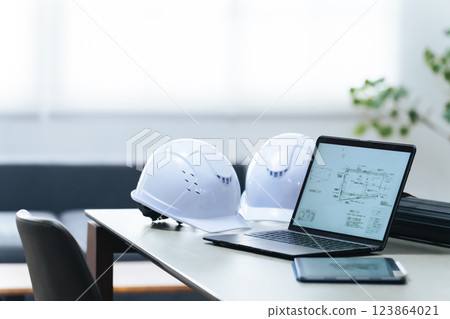 Laptop and helmet in the office Laptop and helmet in the office 123864021