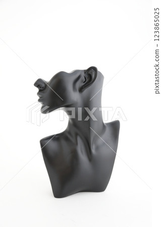 A black object around a person's neck photographed against a white background A black object around a person's neck photographed against a white background 123865025