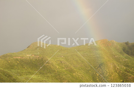 Rainbow over hills. 123865038