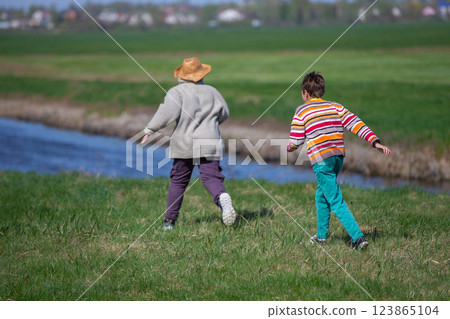 Two boys running after each other in nature. Children on summer holidays. Two boys running after each other in nature. Children on summer holidays. 123865104