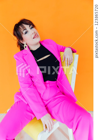 Beautiful fashionable brunette woman in crimson suit Beautiful fashionable brunette woman in crimson suit 123865720