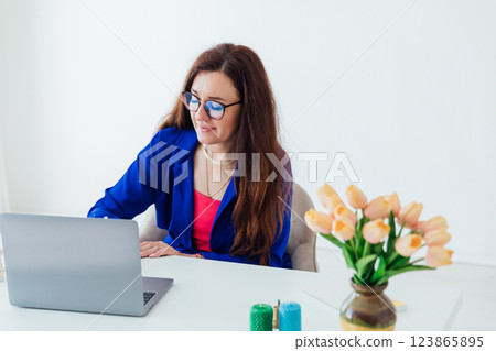 Business woman looking with glasses at office desk Business woman looking with glasses at office desk 123865895