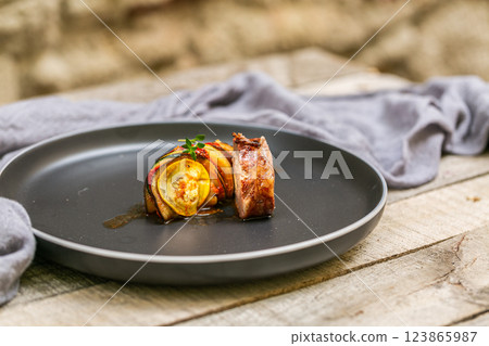 Chef preparing traditional Provencal vegetable dish Ratatouille with stuffed rolled meat on the grill. French food. Healthy eating Chef preparing traditional Provencal vegetable dish Ratatouille with stuffed rolled meat on the grill. French food. Healthy eating 123865987