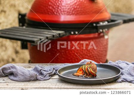 Chef preparing traditional Provencal vegetable dish Ratatouille with stuffed rolled meat on the grill. French food. Healthy eating Chef preparing traditional Provencal vegetable dish Ratatouille with stuffed rolled meat on the grill. French food. Healthy eating 123866071
