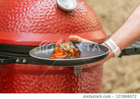 Chef preparing traditional Provencal vegetable dish Ratatouille with stuffed rolled meat on the grill. French food. Healthy eating Chef preparing traditional Provencal vegetable dish Ratatouille with stuffed rolled meat on the grill. French food. Healthy eating 123866072