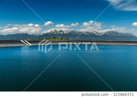 The most famous Slovak peak in the High Tatras - Krivan. A view of the Cierny Vah hydroelectric power plant. 123866351