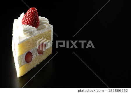 Strawberry shortcake photographed against a black background Strawberry shortcake photographed against a black background 123866362