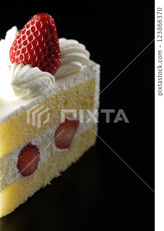 Strawberry shortcake photographed against a black background 123866370