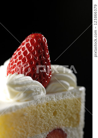 Strawberry shortcake photographed against a black background 123866379