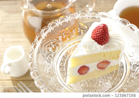 Strawberry shortcake on a cake stand and tea Strawberry shortcake on a cake stand and tea 123867108