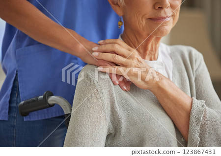 Hand, nurse and elderly woman patient with disability holding hands homecare worker for empathy, kindness and healthcare support. Caregiver, volunteer and trust help for senior woman in wheelchair 123867431