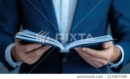Close up of a consultant's hands opening a portfolio, showcasing a professional appearance in a business setting, emphasizing attention to detail and organization. 123867496