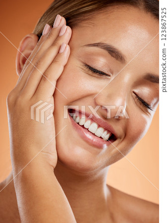 Woman, face and hand with smile for skincare beauty and relax in luxury treatment against studio background. Closeup of a beautiful happy female smiling with teeth in satisfaction for perfect skin 123867525