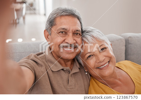 Selfie, couple and love with a senior man and woman sitting on the sofa of their home together for a photograph. Portrait, love and smile with elderly pensioners taking a picture in the living room 123867570