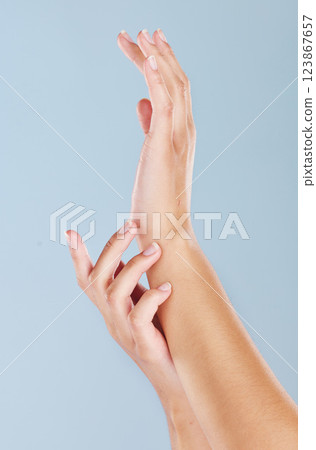 Beauty, skincare and spa with hands of woman for manicure, wellness or health cream massage against blue background in studio. Luxury, cosmetics and clean with palm of girl for salon or dermatology 123867657
