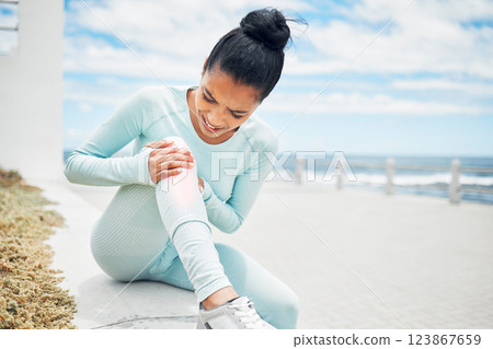 Fitness, exercise and injury with a sports woman on the beach for a workout, training or to go running. Pain, knee and anatomy with a female athlete suffering with a torn ligament or inflammation Fitness, exercise and injury with a sports woman on the beach for a workout, training or to go running. Pain, knee and anatomy with a female athlete suffering with a torn ligament or inflammation 123867659