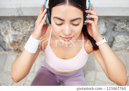 Yoga, headphones and woman listening to music for zen, calm and peace meditation in the city. Health, fitness and girl from Canada doing a pilates exercise with wellness audio, podcast or radio. 123867768