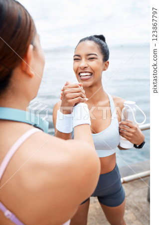 Fitness, woman and handshake for friendship, exercise and workout in healthy lifestyle together in the outdoors. Happy active women celebrating physical training and team routine for sports training 123867797