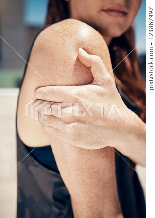 Runner, pain and woman with arm injury outdoors after fitness, running or cardio workout. Health emergency, accident and injured girl, athlete or female hand holding sore shoulder or painful muscle. 123867997