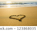 A heart drawn in the sand on the beach 123868035