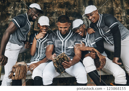 Baseball, sport and phone with a team of men on a bench after training, practice or a game. Teamwork, smartphone and social media exercise with group of players outdoor smile and laugh at funny meme Baseball, sport and phone with a team of men on a bench after training, practice or a game. Teamwork, smartphone and social media exercise with group of players outdoor smile and laugh at funny meme 123868155
