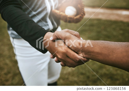 Baseball players handshake before game at baseball field for good luck, agreement and support. Sports, fitness and athletes shaking hands to show unity, well wishes and hope for success during match 123868156