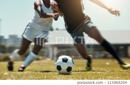 Football, sports and team legs in game on a field while passing, touching and running with a ball. Active, fast and skilled soccer players in a competitive game with workout on a sport pitch outdoors Football, sports and team legs in game on a field while passing, touching and running with a ball. Active, fast and skilled soccer players in a competitive game with workout on a sport pitch outdoors 123868204