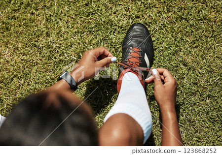 Shoes tie, sports and soccer black woman athlete on green grass ready for exercise and training. Fitness, workout and game of a healthy person player before football cardio in nature and summer 123868252