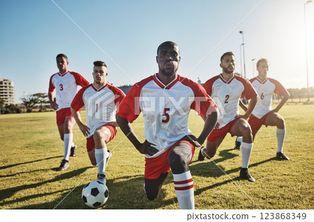Soccer, men and team stretching on field before sports game or training exercise. Health, fitness and teamwork, football competition players stretch on grass together for strong performance in match. Soccer, men and team stretching on field before sports game or training exercise. Health, fitness and teamwork, football competition players stretch on grass together for strong performance in match. 123868349