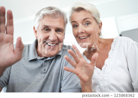 Senior couple, wave and home video call, talking or speaking or discussion. Retirement, happy elderly man and woman greeting on online, web or internet video conference in house together with smile 123868362