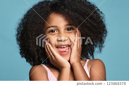 Happy girl, child and excited surprise face of a kid in a studio with happiness and wow expression. Portrait of a young model from Chicago with natural hair showing a smile, omg and shock pose Happy girl, child and excited surprise face of a kid in a studio with happiness and wow expression. Portrait of a young model from Chicago with natural hair showing a smile, omg and shock pose 123868378
