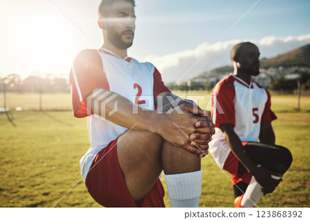 Soccer, football and team stretching legs for match warm up, game or practice. Sports, group and men stretch outdoor on pitch preparing for training, exercise or workout on grass field outdoors. Soccer, football and team stretching legs for match warm up, game or practice. Sports, group and men stretch outdoor on pitch preparing for training, exercise or workout on grass field outdoors. 123868392