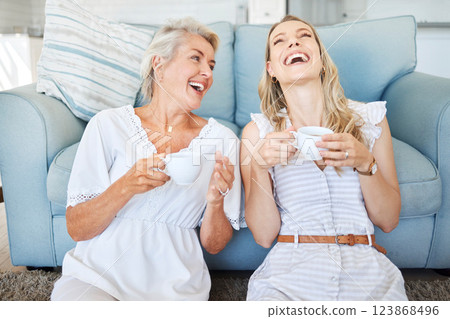 Coffee, mother and daughter with comic communication together on the living room floor of their house. Funny, happy and elderly mom with her child, tea and conversation in the lounge of their home 123868496