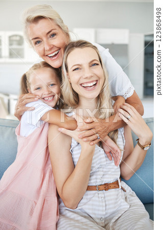 Portrait of grandmother, mother and girl child with smile sitting on sofa to relax, bond and hug. Happy grandma, mom and kid relaxing on couch together in living room of the family home in Australia. 123868498