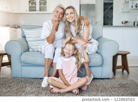 Mom, child and grandmother portrait on sofa for female generations in happy family relaxing. Love, care and bond of women relatives with smile at living room couch together at home in Canada. Mom, child and grandmother portrait on sofa for female generations in happy family relaxing. Love, care and bond of women relatives with smile at living room couch together at home in Canada. 123868503