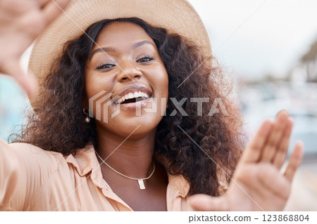Black woman, portrait smile and travel hands for picture perfect day on summer vacation in the outdoors. Face of happy African female traveler smiling with hand frame for capture or photography Black woman, portrait smile and travel hands for picture perfect day on summer vacation in the outdoors. Face of happy African female traveler smiling with hand frame for capture or photography 123868804