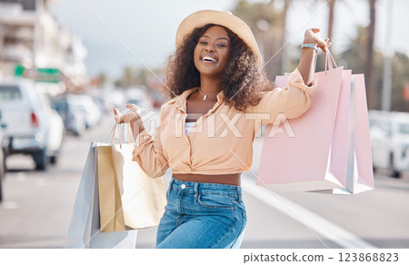 Fashion black woman with shopping bags in city or happy with sale, discount or luxury retail brands of clothes. Customer with smile, boutique products or designer gift form store or shopping mall Fashion black woman with shopping bags in city or happy with sale, discount or luxury retail brands of clothes. Customer with smile, boutique products or designer gift form store or shopping mall 123868823